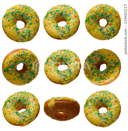 Yellow glazed donuts, each decorated with multi colored sprinkles. 129483217