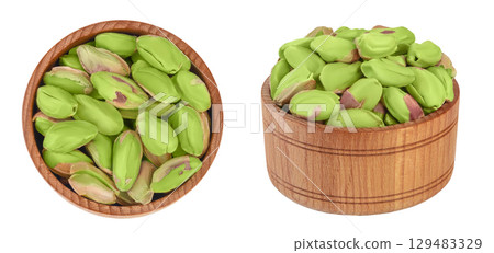 peeled pistachio in wooden bowl isolated on white background with  full depth of field. Top view. Flat lay 129483329