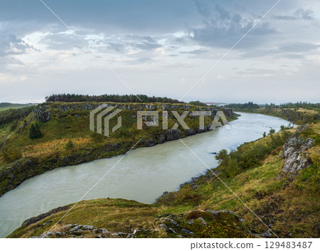 Hrutey island public park near Blonduos town, North-West of Iceland. View during auto trip by Ring Road. Spectacular Icelandic landscape with scenic autumn nature and Blanda river with cataracts. 129483487