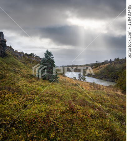 Hrutey island public park near Blonduos town, North-West of Iceland. View during auto trip by Ring Road. Spectacular Icelandic landscape with scenic autumn nature and Blanda river with cataracts. 129483488
