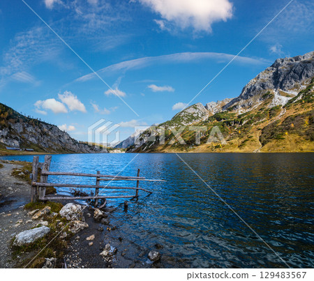 Sunny autumn alpine Tappenkarsee lake and rocky mountains above, Kleinarl, Land Salzburg, Austria. Sunny autumn alpine Tappenkarsee lake and rocky mountains above, Kleinarl, Land Salzburg, Austria. 129483567