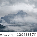 Mystic cloudy and foggy autumn alpine mountain slopes scene. Austrian Lienzer Dolomiten Alps. 129483575