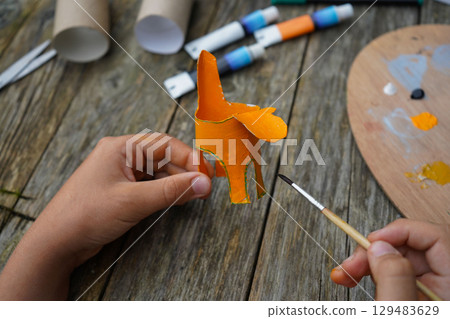 DIY and kid's creativity. Step by step instruction: how to make tiger from toilet roll tube. Step four, cover the entire roll with orange paint. DIY and kid's creativity. Step by step instruction: how to make tiger from toilet roll tube. Step four, cover the entire roll with orange paint. 129483629