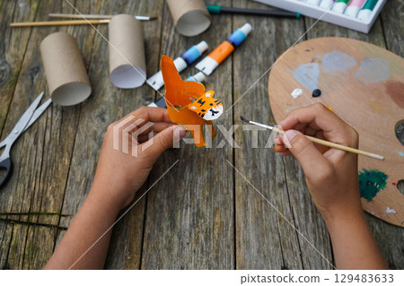 DIY and kid's creativity. Step by step instruction: how to make tiger from toilet roll tube. Step five: draw the tiger's face. 129483633