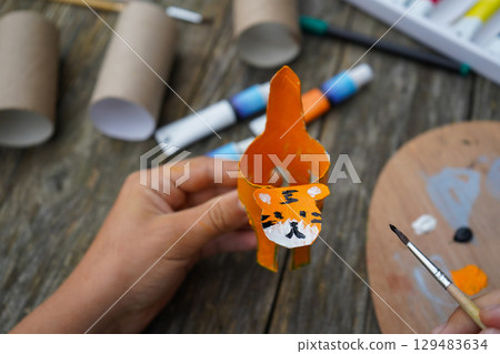 DIY and kid's creativity. Step by step instruction: how to make tiger from toilet roll tube. Step five: draw the tiger's face. 129483634