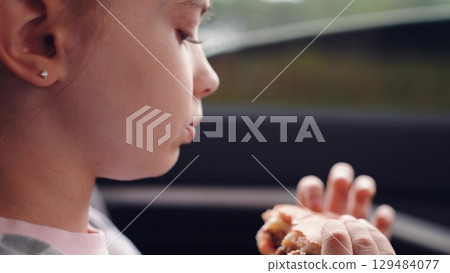 little girl child eating burger in car, happy person, girl enjoying burger car, Child eating cheeseburger during road trip, Little girl having snack back seat, Kid fast food on the go, Happy child little girl child eating burger in car, happy person, girl enjoying burger car, Child eating cheeseburger during road trip, Little girl having snack back seat, Kid fast food on the go, Happy child 129484077