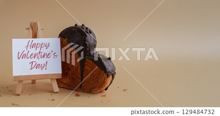 HAPPY VALENTINE'S DAY greeting paper holiday card Delicious fresh croissant topped with Dark chocolate flavor Ganache. Creation unique heart shape bakery. Puff pastry love gift present idea 129484732