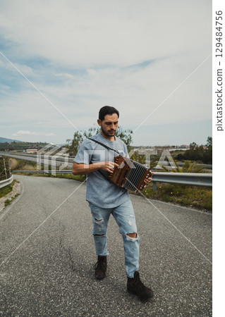 Man Walking Home With His Accordion 129484756