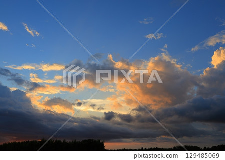 Clouds illuminated by the setting sun Clouds illuminated by the setting sun 129485069