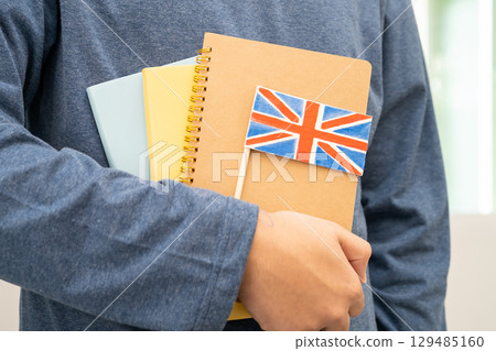 Learn English language, Asian teenage student hold book with flag in course at school. Learn English language, Asian teenage student hold book with flag in course at school. 129485160