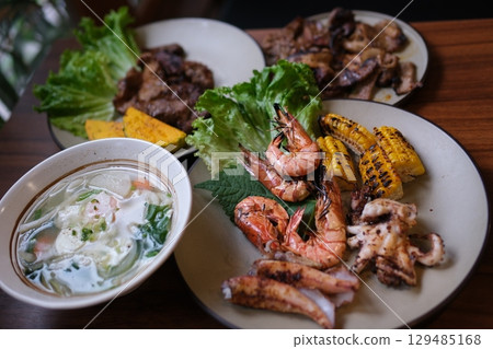 noodle soup. thick pasta soup asian cuisine seafood shrimp corn greens 129485168