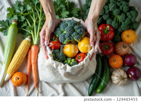 Person holding bag fresh vegetables 129485455