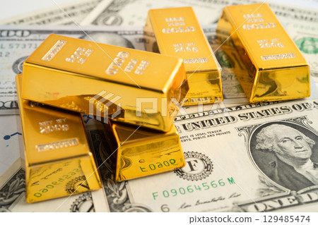 Gold bars with US dollar banknote money, finance trading investment business currency. Gold bars with US dollar banknote money, finance trading investment business currency. 129485474