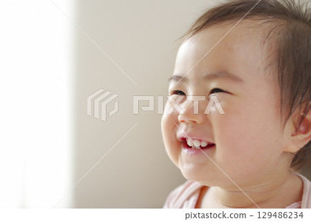 Innocent smiling baby portrait Innocent smiling baby portrait 129486234