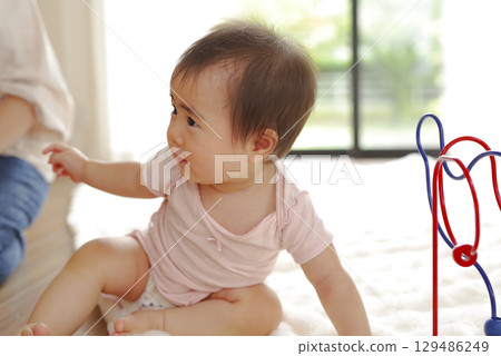 Portrait of a baby playing indoors 129486249