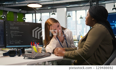 Colleagues bonding at work, sharing personal issues during break, reassuring each other. Coworkers forging the strongest friendships in office, sharing problems and supporting each other, camera A 129486692