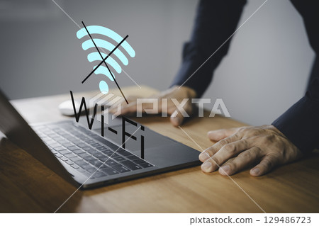 Male user using a laptop computer to connect to Wi-Fi, representing internet connectivity issues, network failure, offline mode, or technology disruption. Male user using a laptop computer to connect to Wi-Fi, representing internet connectivity issues, network failure, offline mode, or technology disruption. 129486723