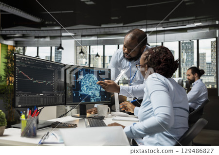 Team of traders in office using deep learning models to enhance predictive accuracy of stock market movements. African american prop firm coworkers leveraging AI to optimize trading strategies 129486827