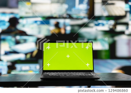 Mockup chroma key on a pc next to satellite imagery of enemy positions, high tech defense forces mission center used to gather intelligence for war planning. Secure global operations. 129486860