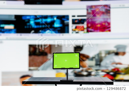 Close up of mockup tablet and video distribution service dashboard. Chroma key device and videowall of trending clips showcasing popular internet media and global streaming trends Close up of mockup tablet and video distribution service dashboard. Chroma key device and videowall of trending clips showcasing popular internet media and global streaming trends 129486872