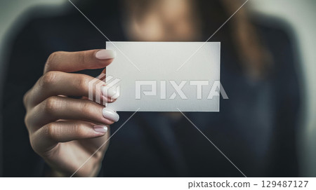 Blank Business Card Held by Professional Woman in Business Attire 129487127