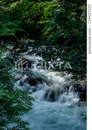 A rapids flowing through rocky areas b-1 A rapids flowing through rocky areas b-1 129487297