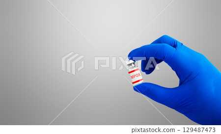 Researcher holding a vaccine for the monkeypox virus (MPOX). Monkeypox disease Researcher holding a vaccine for the monkeypox virus (MPOX). Monkeypox disease 129487473