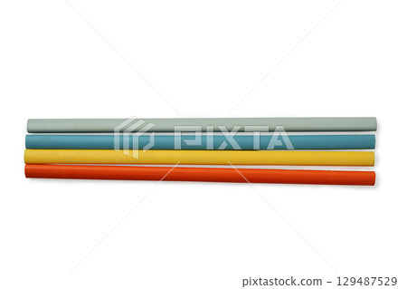 Row of unsharpened colorful wooden pencils isolated over a white background. Concept of stationery Row of unsharpened colorful wooden pencils isolated over a white background. Concept of stationery 129487529