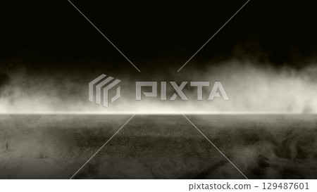 Black background with smoke and steam. The smoke is thick and dark, and the steam is rising from the ground. Dramatic smoke or fog effect. Mockup. Copy Space. Wallpaper or Halloween background 129487601