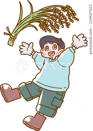 圖：一個微笑的男孩舉起收穫的稻米 129487821