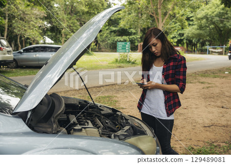 Women fix car call for help use phone calling insurance agent help fixing car problem breakdown. Woman calling mechanic car service technician support fix repair driving. Vehicle emergency problem Women fix car call for help use phone calling insurance agent help fixing car problem breakdown. Woman calling mechanic car service technician support fix repair driving. Vehicle emergency problem 129489081