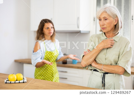 Offended old woman quarreling with her daughter at home 129489267