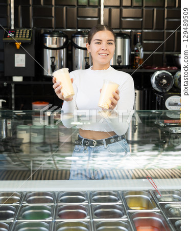 Young woman works as bartender and sells bubble tea 129489509