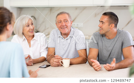 Married couple and senior parents talk about home life Married couple and senior parents talk about home life 129489747