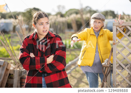 Farm neighbors quarrel over farm backyard in day Farm neighbors quarrel over farm backyard in day 129489888