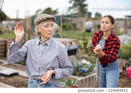 Conflict between female neighbors in country farm Conflict between female neighbors in country farm 129489932