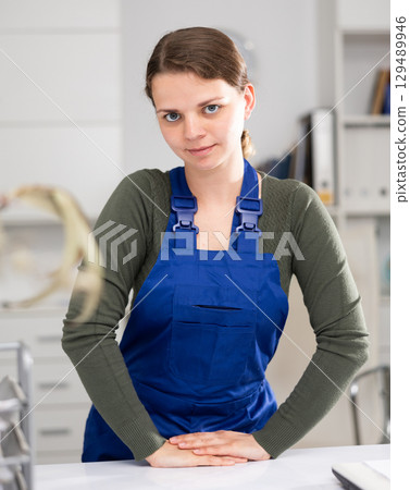 Female office cleaner is satisfied after cleaning in office Female office cleaner is satisfied after cleaning in office 129489946
