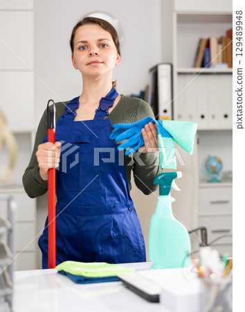 Female cleaner in protective uniform at company office Female cleaner in protective uniform at company office 129489948