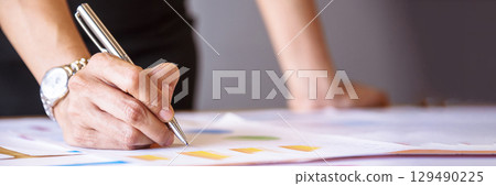 Banner Businesswoman hands note meeting document in conference room. Woman Hands writing planning on notebook. Female hand holding pencil write on diary sketchbook. Business Planning with copy space 129490225