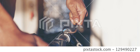 Banner Man hands fixing Car machinery vehicle mechanical service. Mechanic man hands repairing car shop. panoramaopen vehicle hood checking up auto mobile. Car maintenance engineer with copy sapce. 129490227