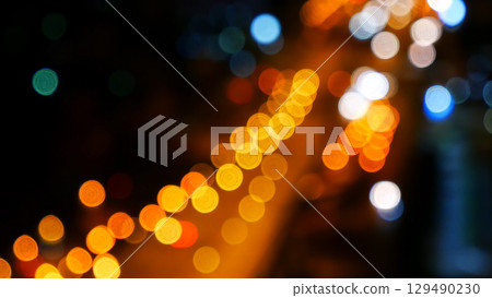 Blurred background night city bokeh car drive on road in nightlife. Light line traffic jam in black night. Blur street flare traffic motion movement. Cityscape Urban dark background twilight time Blurred background night city bokeh car drive on road in nightlife. Light line traffic jam in black night. Blur street flare traffic motion movement. Cityscape Urban dark background twilight time 129490230