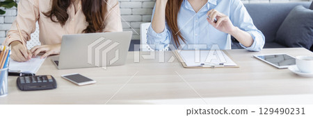 Banner Happy success business woman partner meeting working together in company office. Panoramic picture of Meeting Executive Asian business woman office desk with fist arm raised executive teamwork Banner Happy success business woman partner meeting working together in company office. Panoramic picture of Meeting Executive Asian business woman office desk with fist arm raised executive teamwork 129490231