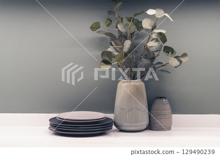 Plant pot office decor on wood table. Green decorate home office desk. Green potted plant on wood office desk in springtime garden. Fern bush green leaf foliage floral Houseplant home office decor Plant pot office decor on wood table. Green decorate home office desk. Green potted plant on wood office desk in springtime garden. Fern bush green leaf foliage floral Houseplant home office decor 129490239