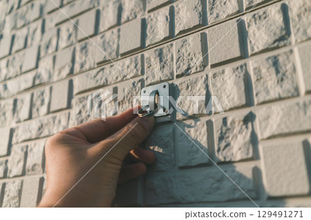 Attach the brackets that secure the sunshade to the exterior wall of your house. Attach the brackets that secure the sunshade to the exterior wall of your house. 129491271