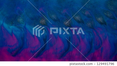 Paint splatter. Neon background. Defocused purple pink blue color shimmer flow particles spreading on creative acrylic abstraction. Paint splatter. Neon background. Defocused purple pink blue color shimmer flow particles spreading on creative acrylic abstraction. 129491796