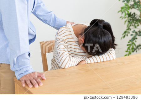 A father comforting a depressed middle school girl 129493386