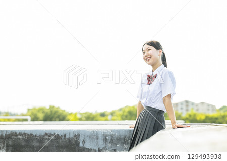 High school girls relaxing on the school rooftop 129493938