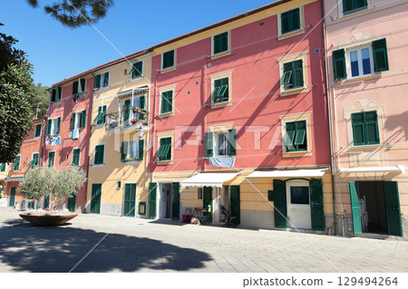 Old street in Italian countryside near sea. Traditional building. Sun day. Entrance, window to house. Nature and sky. Old street in Italian countryside near sea. Traditional building. Sun day. Entrance, window to house. Nature and sky. 129494264