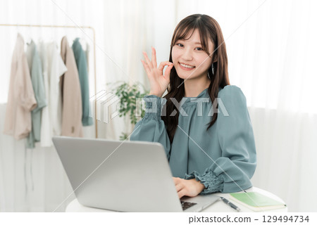 Young Asian businesswoman using a laptop in the office Young Asian businesswoman using a laptop in the office 129494734