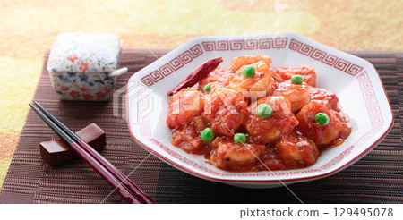 Glossy and fragrant shrimp chili. A classic Chinese dish. Colorful stir-fried shrimp in chili sauce. Perfect for advertising. 129495078